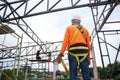 Workers prepare to go up with Fall arrestor device for worker with hooks for safety body harness on onstruction site Royalty Free Stock Photo