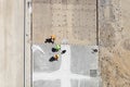 Workers Preparing Concrete Slab Under Developing Construction.