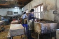 Workers process pulp at a small paper factory