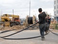 Workers pull the electrical cable