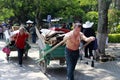 Workers pull wooden handcart