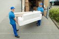 Workers Putting Furniture And Boxes In Truck Royalty Free Stock Photo