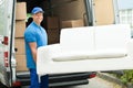 Workers Putting Furniture And Boxes In Truck Royalty Free Stock Photo