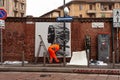 Workers are putting up posters showcasing the Moncler collection of 2023 on the walls, Milan