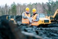 Workers in quarry looking at a plan