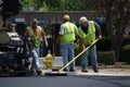 Workers raking asphalt Royalty Free Stock Photo