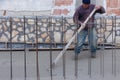 Workers with rake leveled the concrete