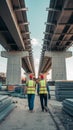 Workers in red hard hats and yellow vests walk on construction site with scattered materials Royalty Free Stock Photo