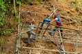 Workers reinforce the mountainside to prevent landslides on the road