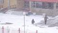 Workers remove snow in winter, work with shovels