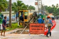 Workers removed a layer of asphalt from the road to lay pipes. Repair construction work on the street of the island in Thailand