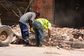 Workers removing rubble from a street