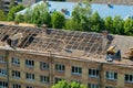 Workers repair and replace roofing on an old red brick building. Spring construction work. Repair and maintenance of city Royalty Free Stock Photo