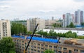 Workers repair and replace roofing on an old red brick building. Spring construction work. Repair and maintenance of city Royalty Free Stock Photo