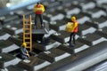 Workers repairing keyboard Royalty Free Stock Photo