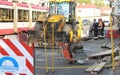 Workers repairing road surface, worker with jackhammer. Group of men in uniform on city street in summer Royalty Free Stock Photo