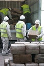 Workers retrieve drug packs from a truck before its destruction