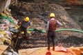 Workers in the river construction, pry an iron shelf