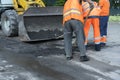 Workers on a road construction, industry and teamwork. builders workers at asphalting paver machine during Road street repairing w