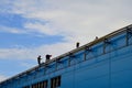 Workers on the roof of the building with insurance perform work on the construction of the building Royalty Free Stock Photo