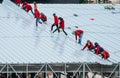 Workers roofing metal for the roof on a large commercial building at Petchkasem road Omnoi, Krathum Baen, Samut Sakhon, Thailand