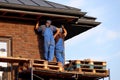 Workers during roofing, two builders on scaffolding