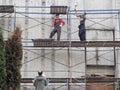 The workers on the scaffolding. Workers on construction sites. Russia. Saint-Petersburg. Summer 2017.