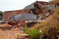 Workers separated huge piece of shale rock and make from it square stone