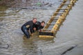 Workers set concrete form work in water