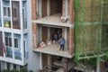 Workers are setting the electricty up in the wall of a bricks building in Vietnam