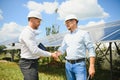 Workers shaking hands on a background of solar panels on solar power plant Royalty Free Stock Photo