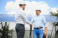 Workers shaking hands on a background of solar panels on solar power plant Royalty Free Stock Photo