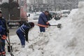 Workers shovel snow