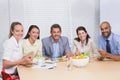 Workers smiling at camera eating sandwiches and salad Royalty Free Stock Photo