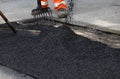 Workers smoothing asphalt