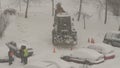 Tractor cleaning the streets from snow in snowfall