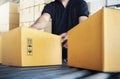 Workers Sorting Packaging Boxes on Conveyor Belt in Distribution Warehouse Center. Supply Chain. Storehouse Shipment Goods. Royalty Free Stock Photo