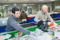 Workers sorting recyclable materials on conveyor