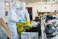 Workers sorting recyclable materials at waste processing plant Royalty Free Stock Photo