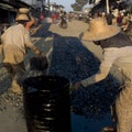 Workers spreading hot tar on the street