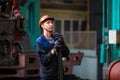 Workers stand behind the machines at the factory and work.