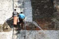Workers stand on ladder and paint a big wall