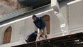 Workers stand on a small porch