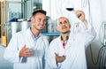 Workers standing with glass of wine Royalty Free Stock Photo