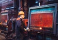 Workers in the steel mill. Factory worker takes a sample for metal.