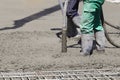 Workers stirring cement with hoses