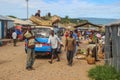 Workers at the street market unload a car with goods