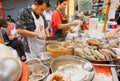 Workers of street restaurant cooking meat dishes outdoor