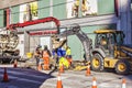 Workers are on the street restoring communications with the excavator and the Sewerage pumping machine . Royalty Free Stock Photo