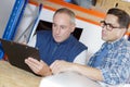 Workers studying clipboard warehouse informaiton Royalty Free Stock Photo